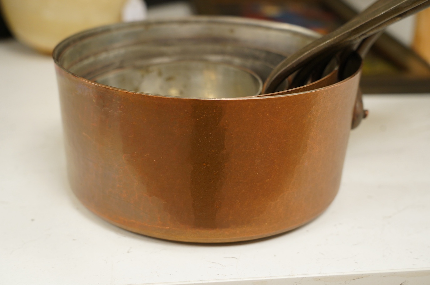 A set of five graduated copper pans, largest diameter 21cm. Condition - fair to good